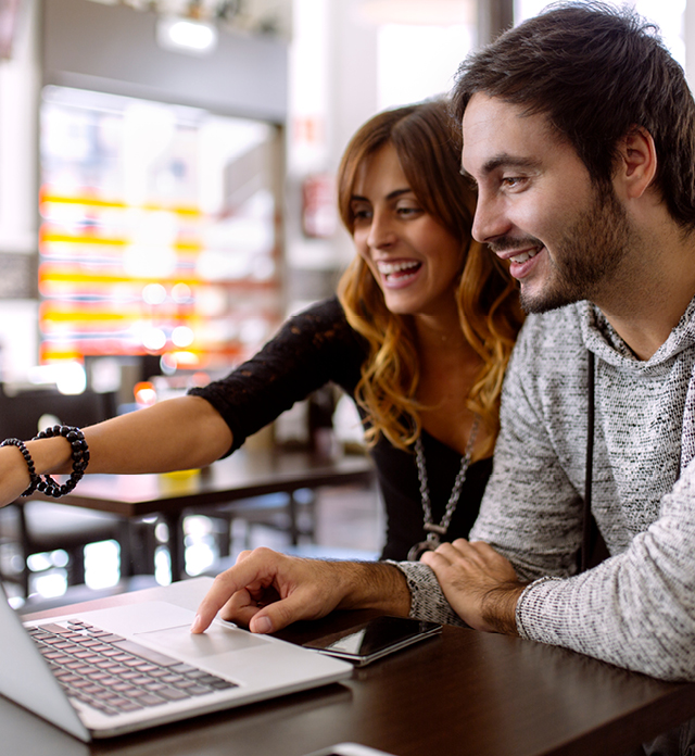 Image of young people using the laptop